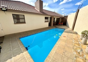 Secunda, 4 bedroom house for sale, modern comfort, walk-in wardrobe, gas hob, scullery, built-in braai, swimming pool, inverter system, JoJo tanks, multi-use room, smart investment.