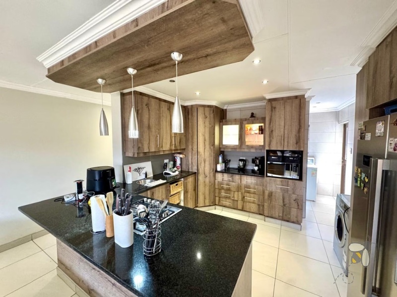 Secunda, 4 bedroom house for sale, modern comfort, walk-in wardrobe, gas hob, scullery, built-in braai, swimming pool, inverter system, JoJo tanks, multi-use room, smart investment.