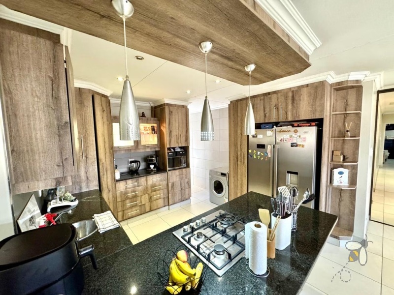 Secunda, 4 bedroom house for sale, modern comfort, walk-in wardrobe, gas hob, scullery, built-in braai, swimming pool, inverter system, JoJo tanks, multi-use room, smart investment.