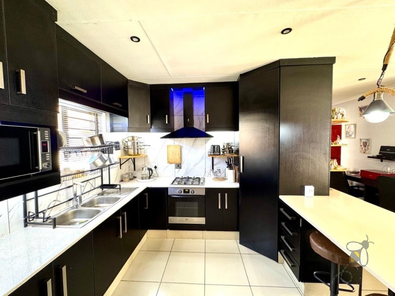 Secunda, 3 bedroom house for sale, modern family home, Caesarstone, gas hob, swimming pool, inverter system, JoJo tank, dual braai, double garage, open plan living, tiled throughout.