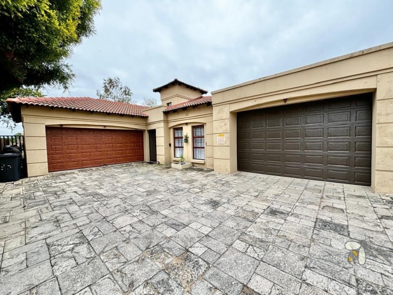 Secunda, Tuscan style home, 3 bedroom house for sale, renovated kitchen, indoor entertainment area, built-in braai, four garages, scullery, luxury living, serene neighborhood.