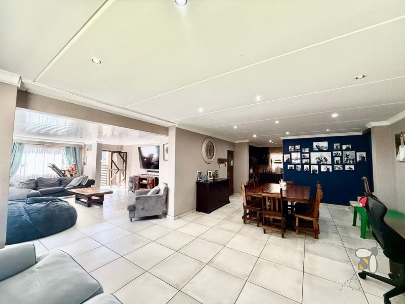 Secunda Central, double-storey home, 3 bedroom house for sale, indoor braai, granite countertops, gas stove, JoJo tank, high security, CCTV, wide staircase, modern living.