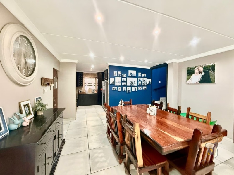 Secunda Central, double-storey home, 3 bedroom house for sale, indoor braai, granite countertops, gas stove, JoJo tank, high security, CCTV, wide staircase, modern living.