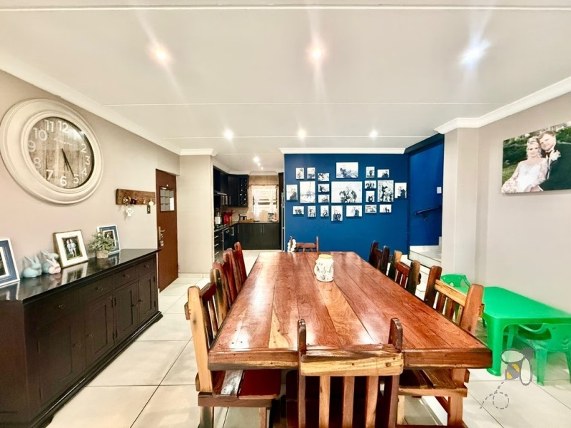 Secunda Central, double-storey home, 3 bedroom house for sale, indoor braai, granite countertops, gas stove, JoJo tank, high security, CCTV, wide staircase, modern living.