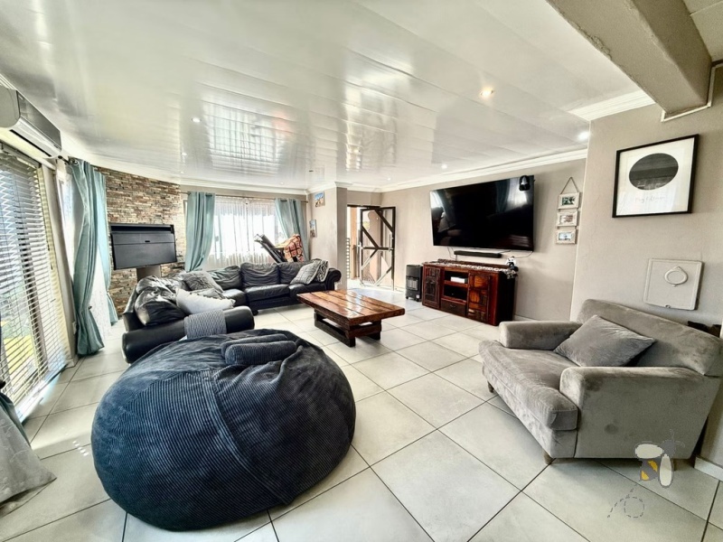 Secunda Central, double-storey home, 3 bedroom house for sale, indoor braai, granite countertops, gas stove, JoJo tank, high security, CCTV, wide staircase, modern living.
