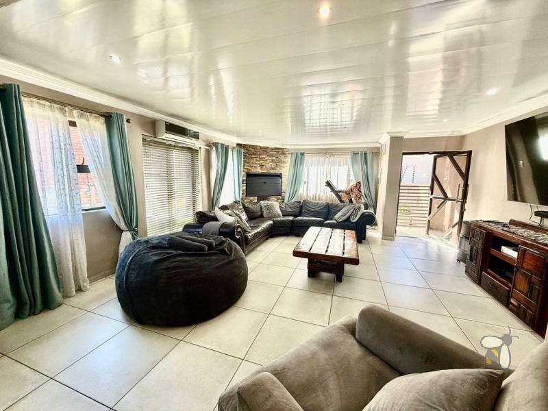 Secunda Central, double-storey home, 3 bedroom house for sale, indoor braai, granite countertops, gas stove, JoJo tank, high security, CCTV, wide staircase, modern living.