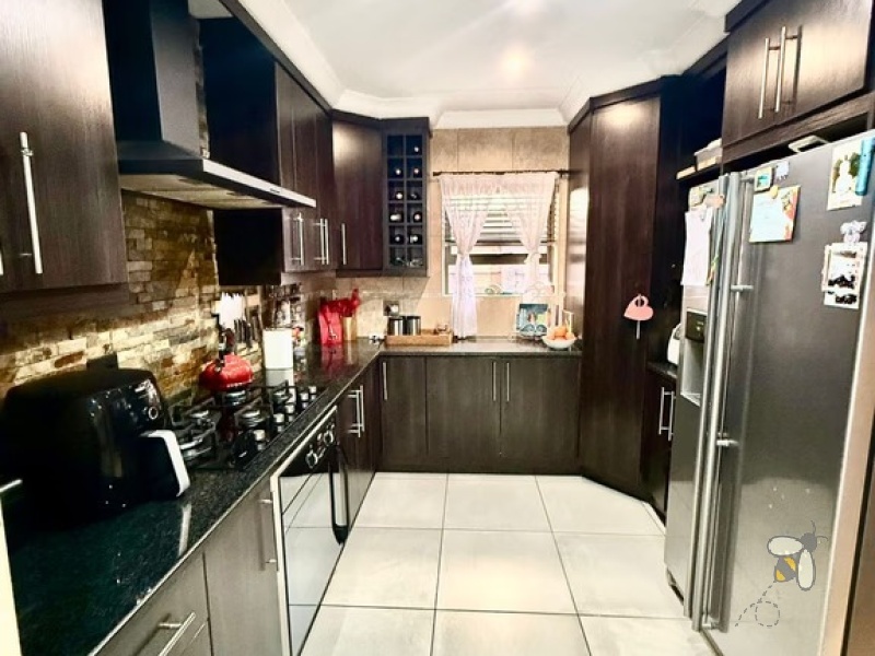 Secunda Central, double-storey home, 3 bedroom house for sale, indoor braai, granite countertops, gas stove, JoJo tank, high security, CCTV, wide staircase, modern living.