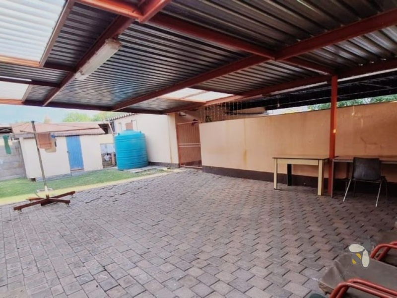 Secunda, 4 bedroom house for sale, secure area, solar panels, JoJo tank, built-in braai, large garden, modern kitchen, family home, sustainable living.