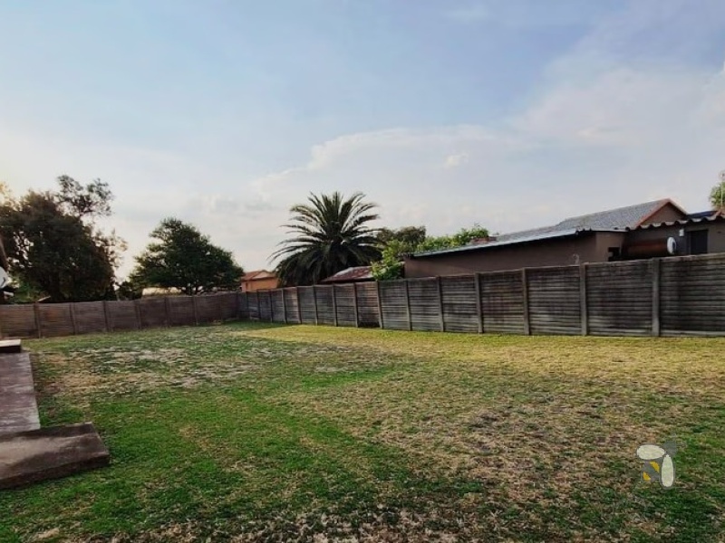Secunda, 4 bedroom house for sale, secure area, solar panels, JoJo tank, built-in braai, large garden, modern kitchen, family home, sustainable living.