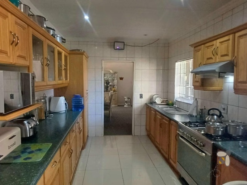 Kosmos Park, 4 bedroom house for sale, inviting home, open-plan living, custom en-suite, two lounges, outside room, income potential, two garages, spacious kitchen.