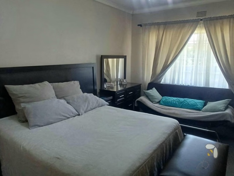 Kosmos Park, 4 bedroom house for sale, inviting home, open-plan living, custom en-suite, two lounges, outside room, income potential, two garages, spacious kitchen.