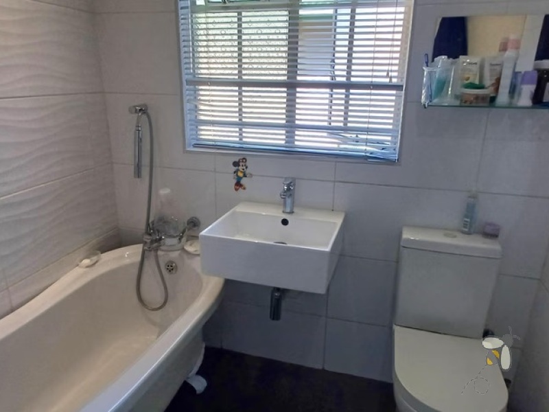 Kosmos Park, 4 bedroom house for sale, inviting home, open-plan living, custom en-suite, two lounges, outside room, income potential, two garages, spacious kitchen.