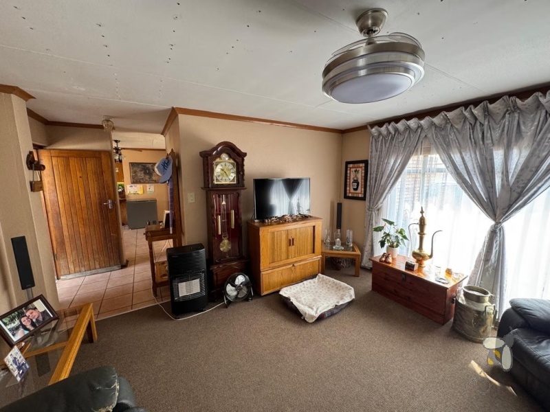 Secunda, 4 bedroom house for sale, brickface home, corner stand, gas hob, built-in braai, Jojo tank, double carports, two living areas, solid construction, scullery.