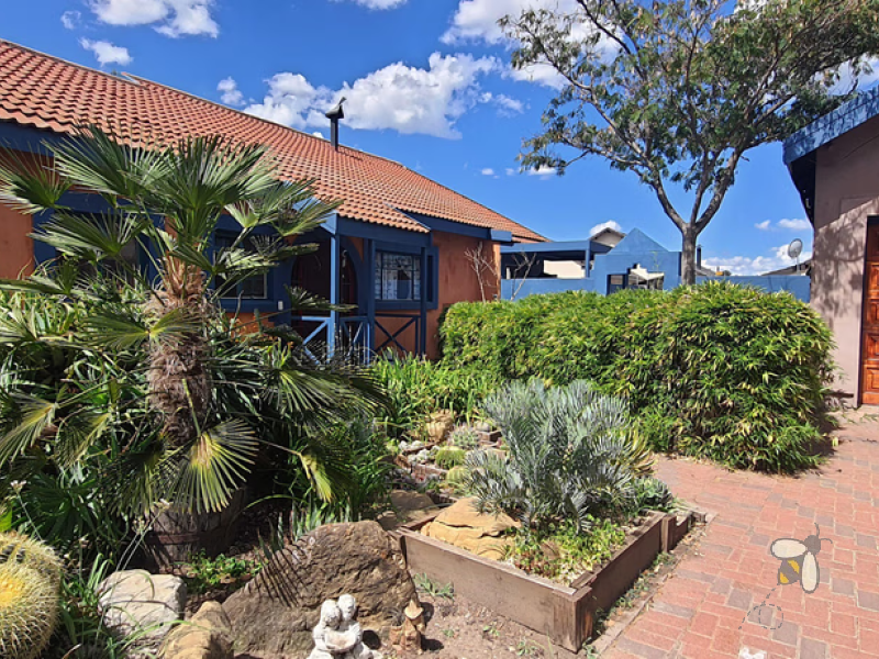 Charming 3-bedroom cottage-style home for sale in Kosmos Park, near schools and amenities. Features open-plan living, a fireplace, security beams, and a large 1062 sqm yard with two entrances. Listed at R1,260,000.