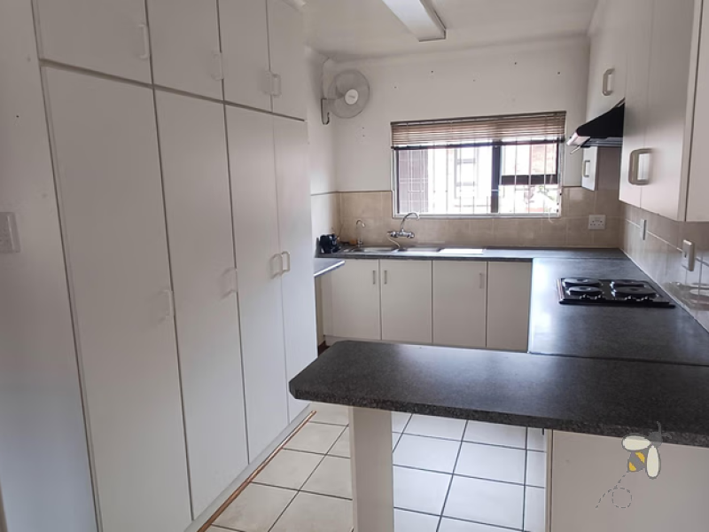 Standerton townhouse for sale, 2 bedroom unit, open plan living, modern kitchen, 2 garages, secure carport, paved courtyard, water tank, low levy