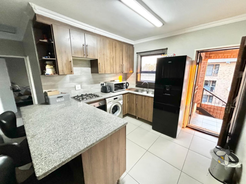 Secunda, apartment for sale, 2 bedroom flat, cozy living, built-in braai, private patio, modern kitchen, shaded parking, well-maintained complex