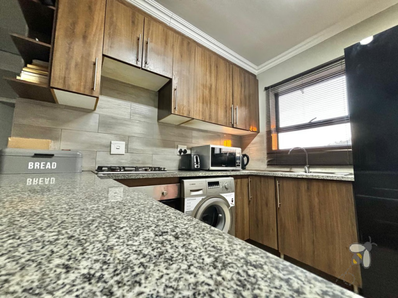 Secunda, apartment for sale, 2 bedroom flat, cozy living, built-in braai, private patio, modern kitchen, shaded parking, well-maintained complex