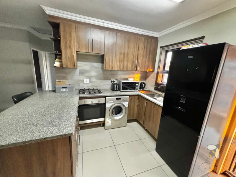 Secunda, apartment for sale, 2 bedroom flat, cozy living, built-in braai, private patio, modern kitchen, shaded parking, well-maintained complex